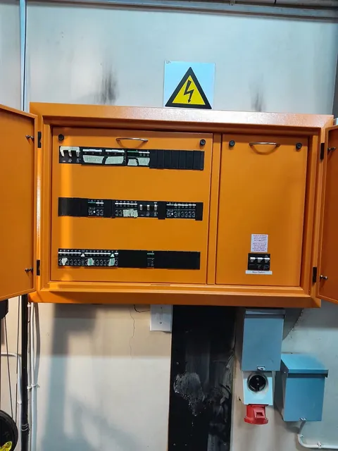 Orange distribution enclosure with hazard sign and closed inner covers