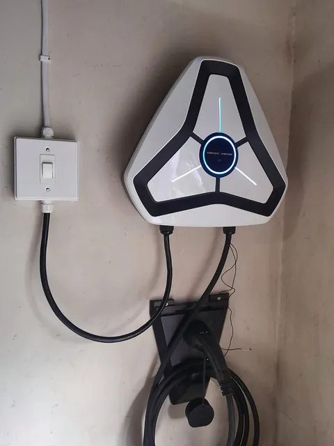 Wall-mounted electric vehicle charger with an isolator switch
