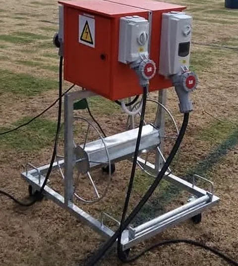 Portable orange power box with two industrial sockets on a cable reel trolley