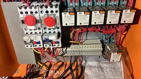 Control panel close-up showing overload relays, relays and a terminal strip